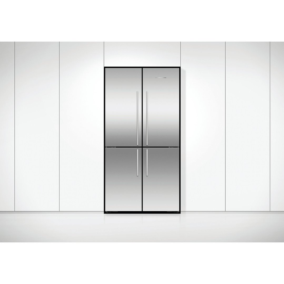 Stainless steel quad door refrigerator freezer in a modern white kitchen setting