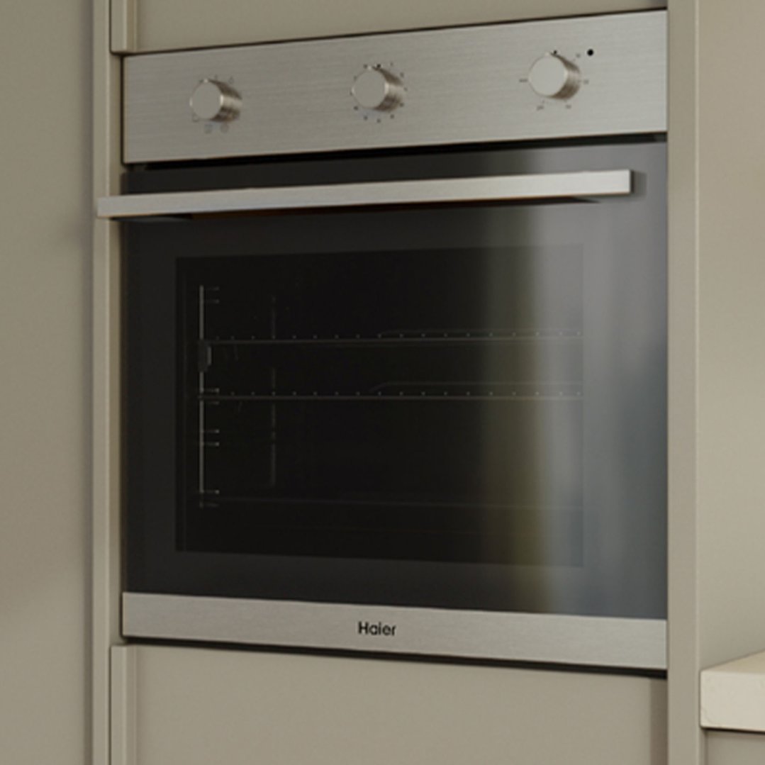 Stainless steel built-in oven with control knobs and glass door in a kitchen setting