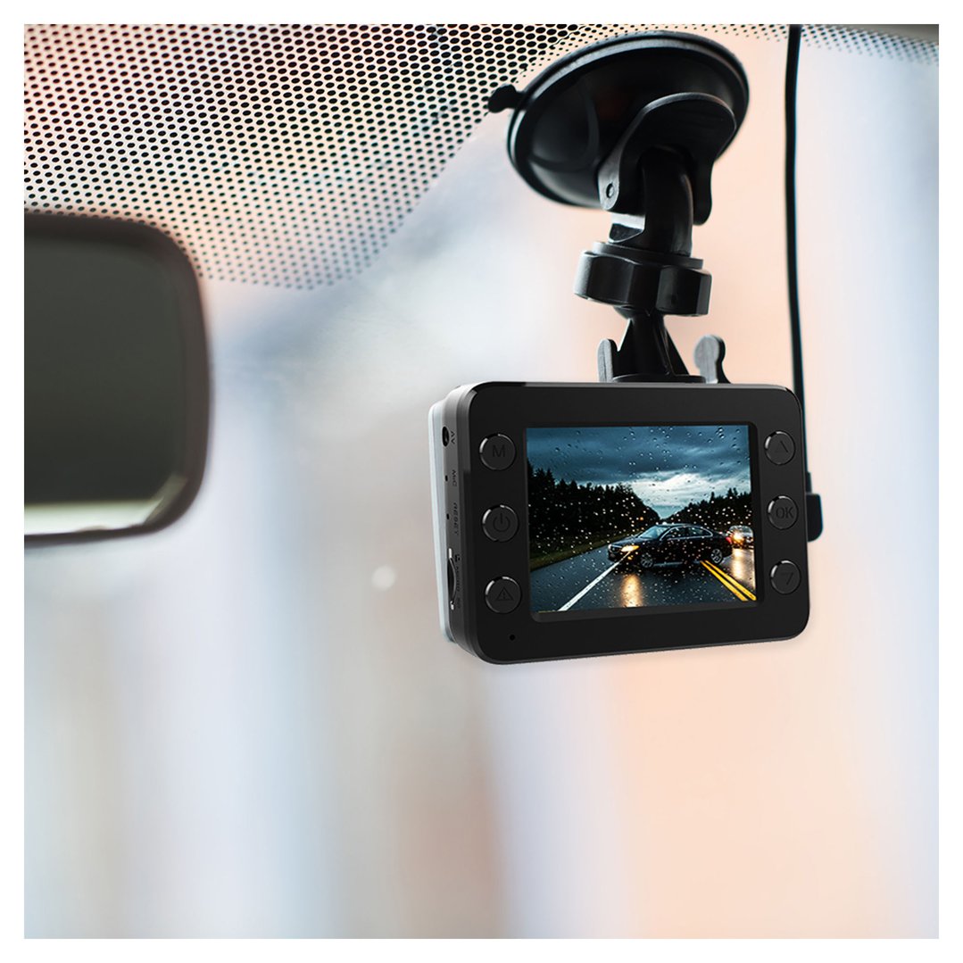 A dash camera mounted on a car windshield, displaying a rainy road scene