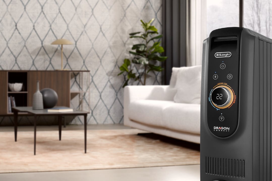 Black DeLonghi Dragon Connect oil column heater in a modern living room