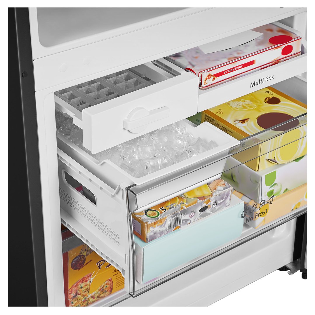Open freezer compartment of a bottom mount fridge with food items inside
