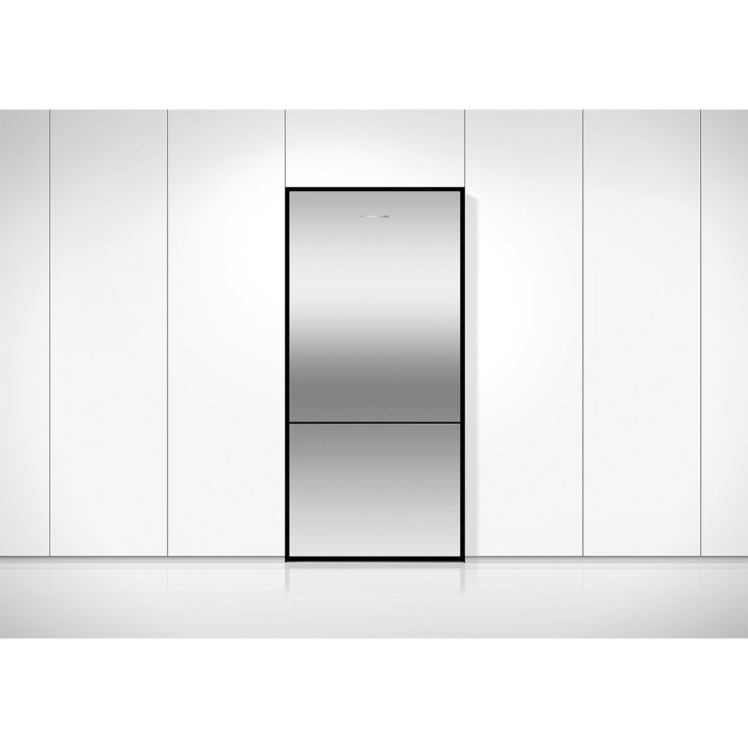 Stainless steel refrigerator freezer integrated into white cabinetry in a modern kitchen
