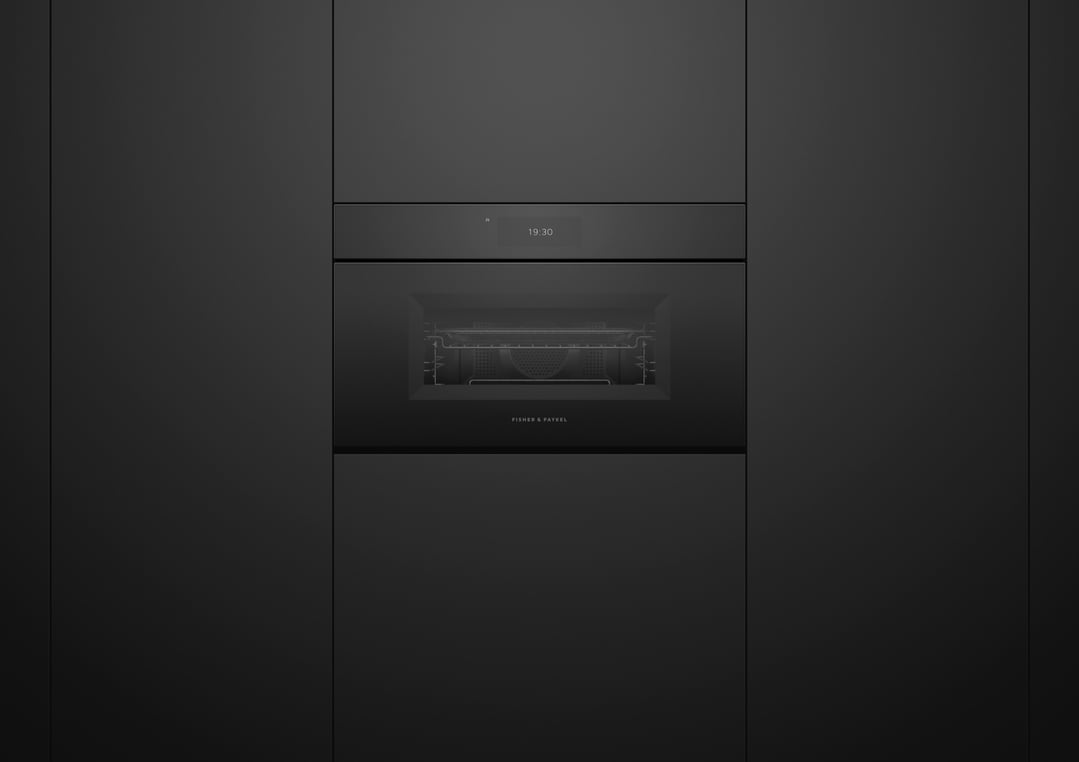 Built-in black microwave oven with a digital display showing 19:30 in a dark kitchen