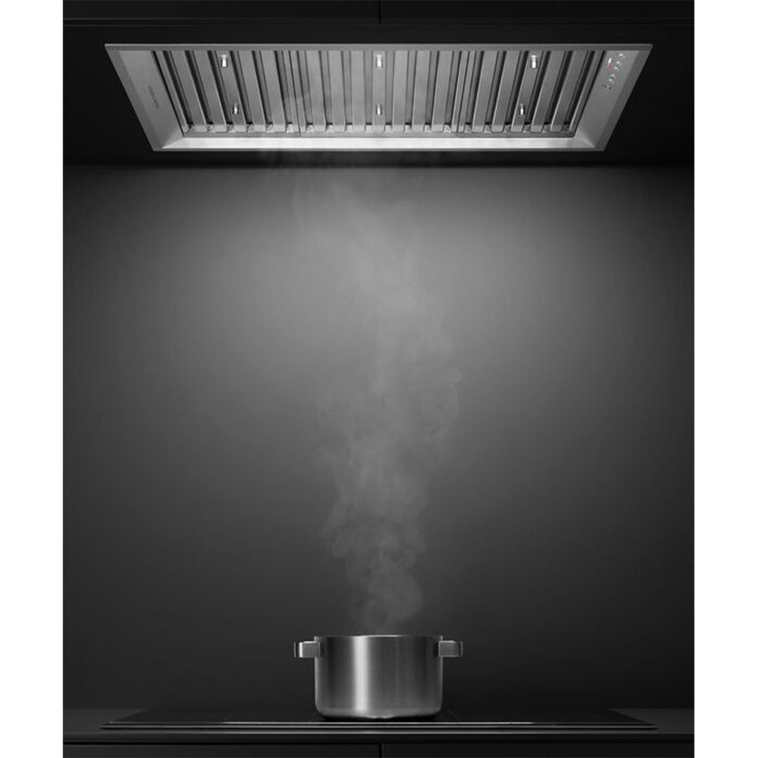 Integrated insert rangehood above a pot of steaming water on a cooktop