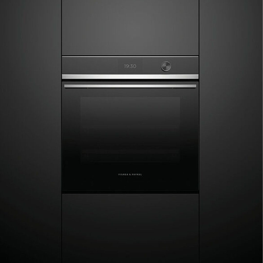 Black compact combi-steam oven built into dark cabinetry