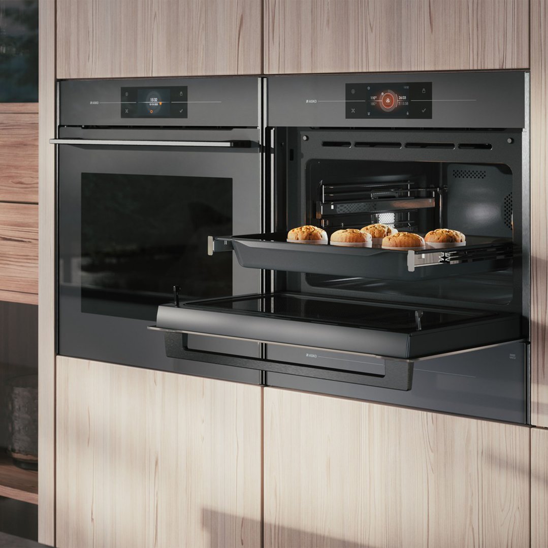 Two built-in microwave ovens in a light wood kitchen cabinet