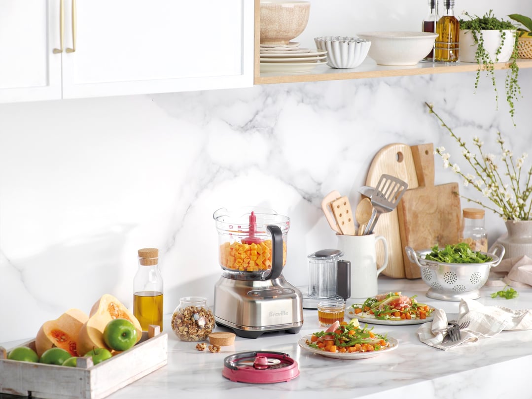 The Paradice 9 Food Processor on a kitchen counter with food and ingredients