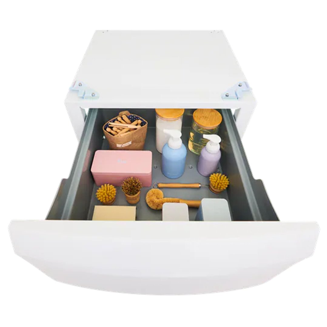 Open laundry pedestal drawer filled with cleaning supplies and accessories