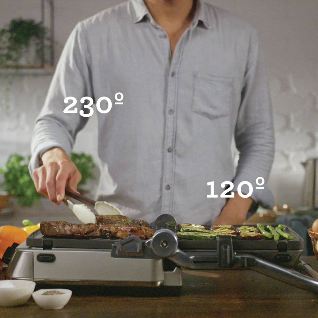 Man grilling meat and vegetables on a Breville Sear & Press Grill