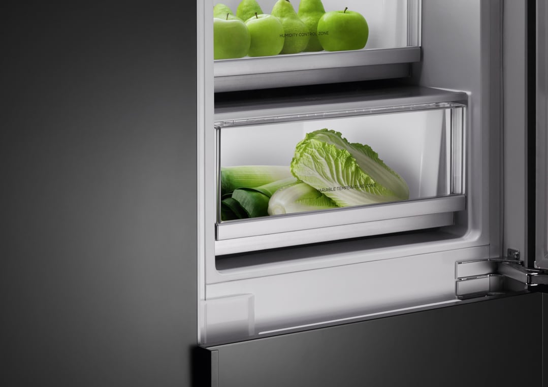 Close up of a refrigerator interior with fresh produce in drawers