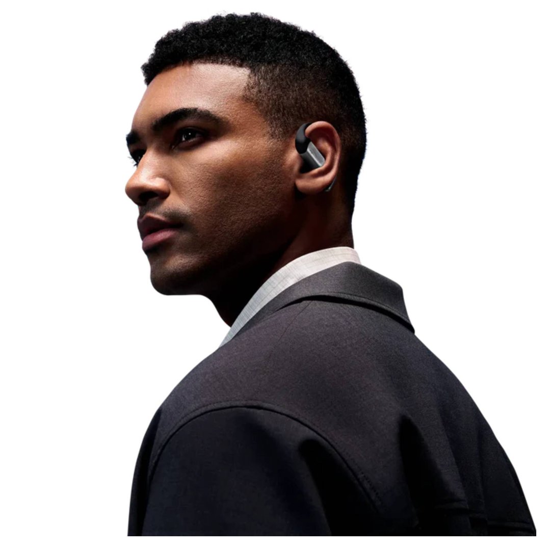 Man wearing a black wireless open-ear headphone in his right ear