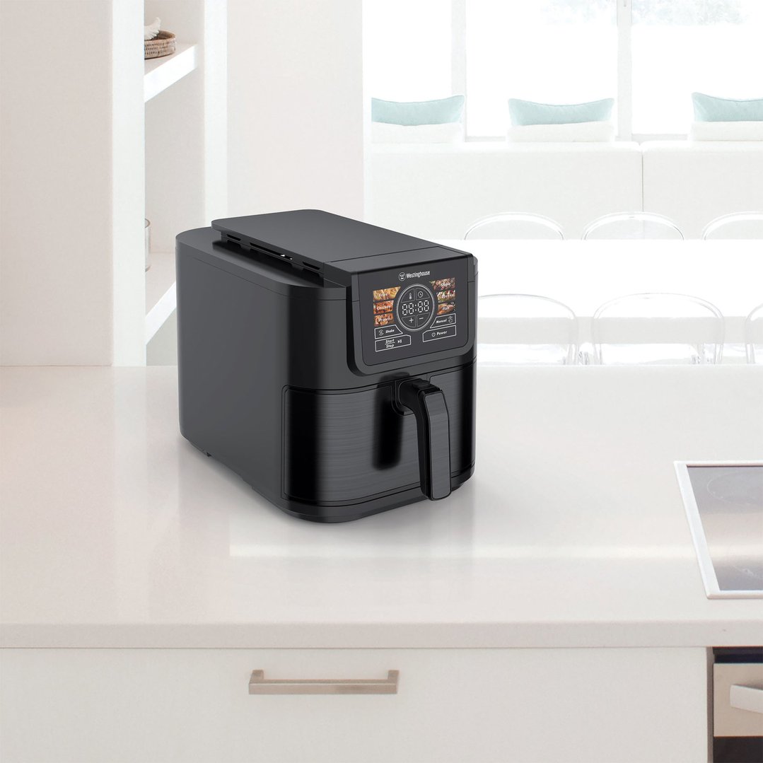 Black Westinghouse air fryer on a white kitchen counter in a bright room