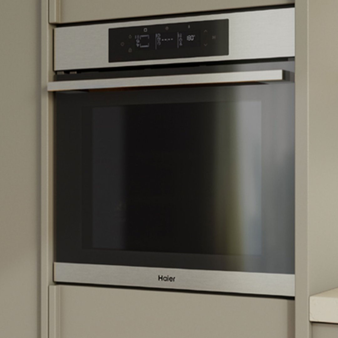 Built-in oven with a black glass door and stainless steel trim in a kitchen