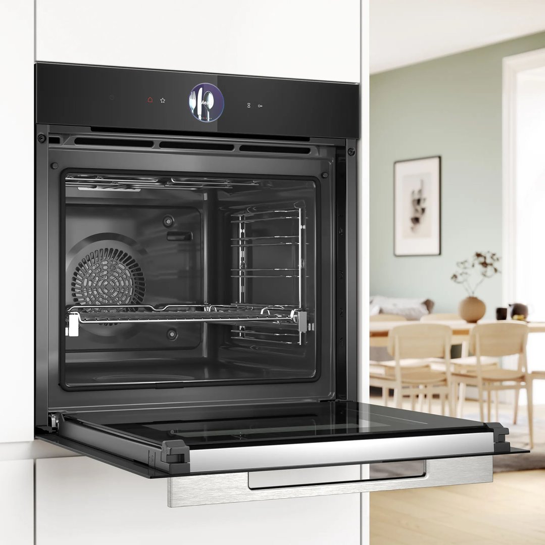 Built-in Bosch oven with door open in a modern kitchen setting