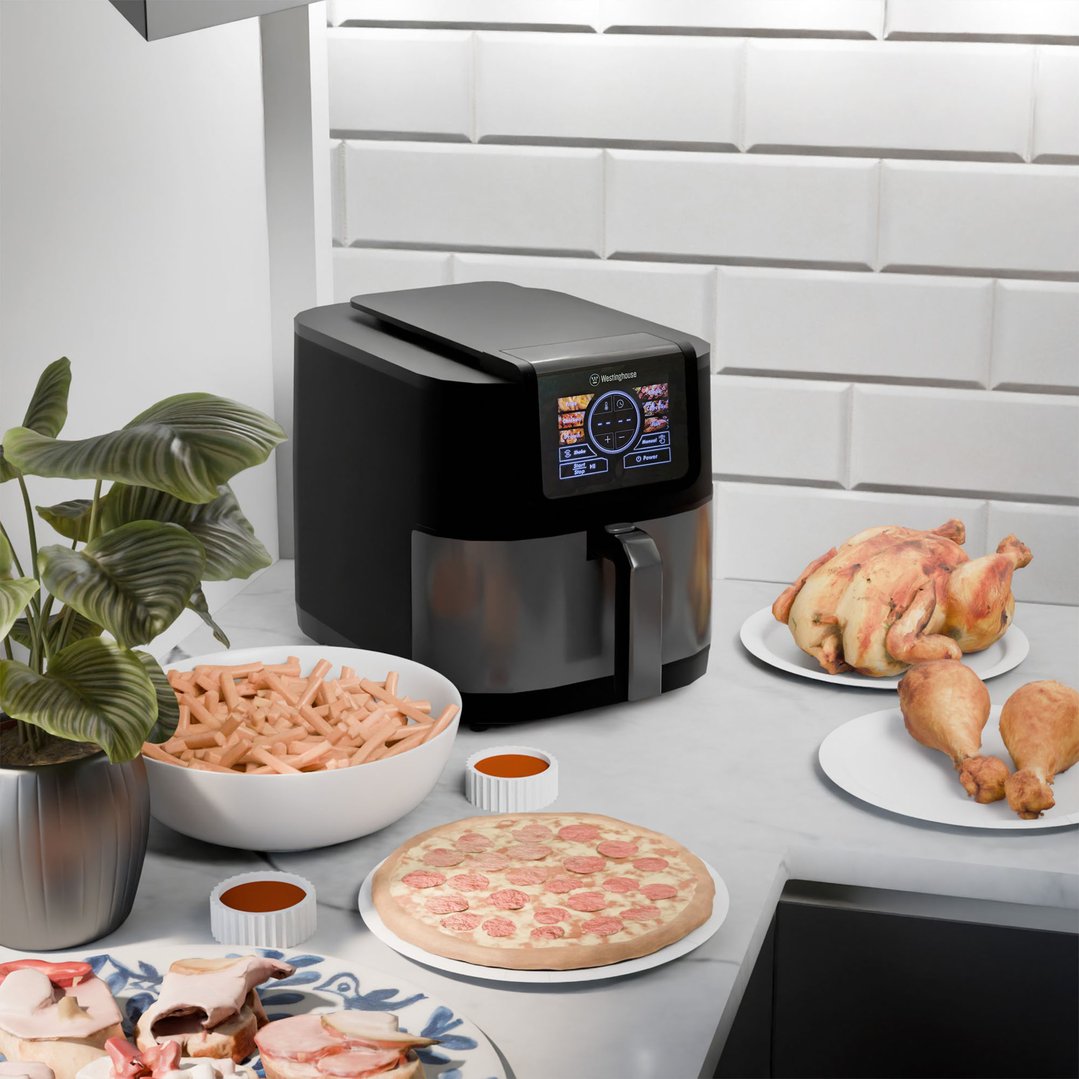 Black Westinghouse air fryer on a kitchen counter with various foods