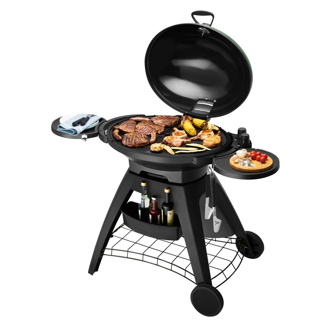 Black barbeque with lid open, cooking meat and vegetables, with side tables