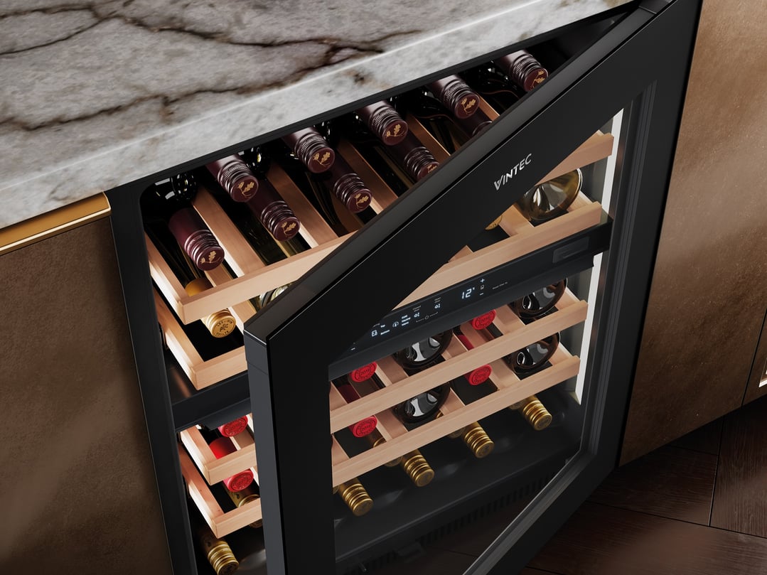 Open Vintec wine cabinet built into a kitchen counter with marble top
