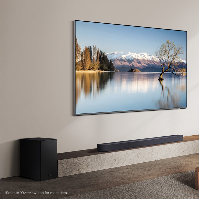 Soundbar and subwoofer in a living room with a TV on the wall