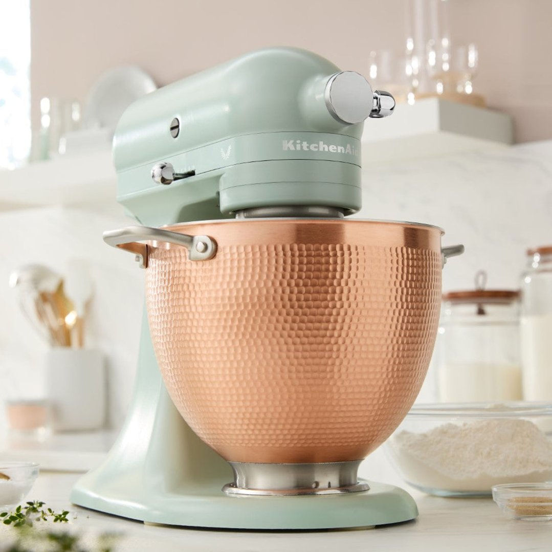 KitchenAid stand mixer with a copper bowl on a kitchen counter with ingredients