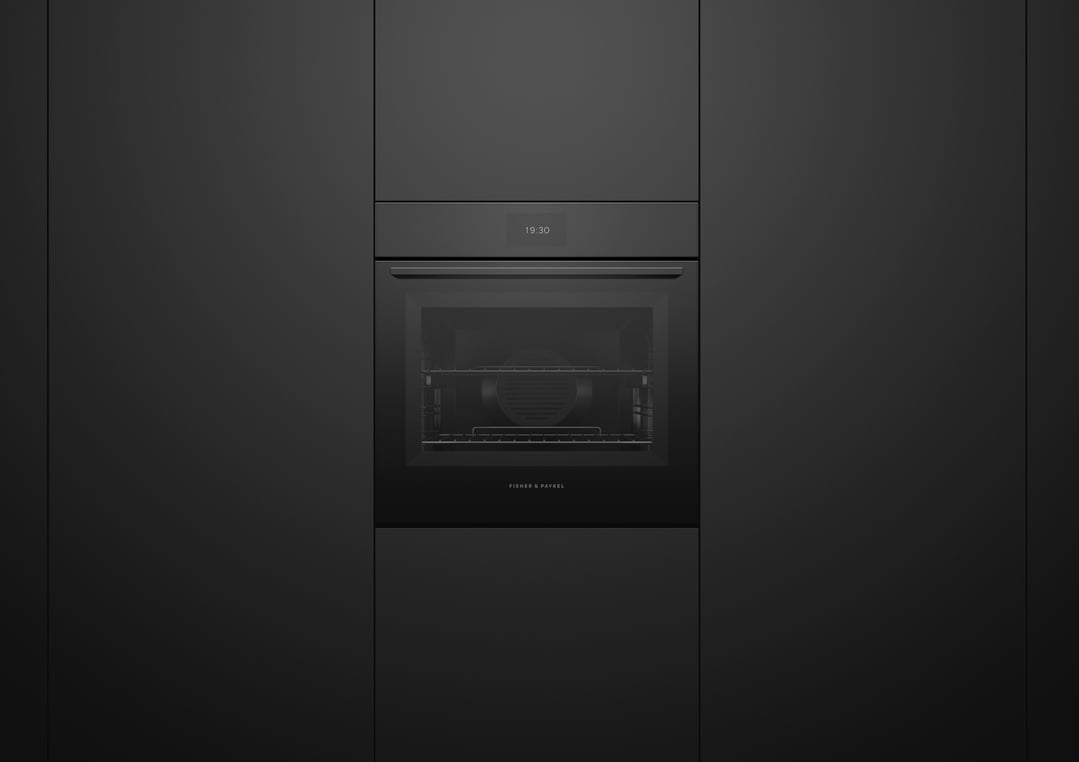 Black built-in oven with a digital display showing 19:30 in a dark kitchen