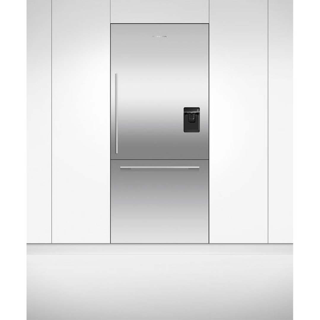 Integrated refrigerator freezer with ice and water dispenser in a white kitchen setting