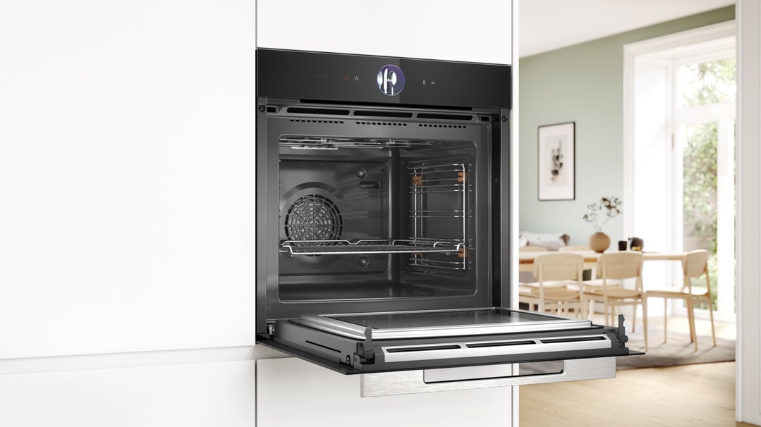 Open built-in Bosch oven with a digital display in a modern kitchen