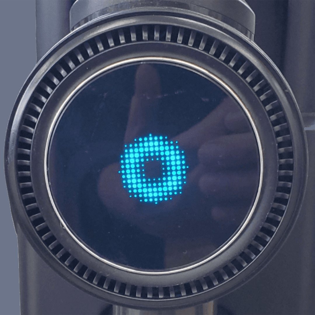 Close up of the display screen on a vacuum cleaner showing a blue circle