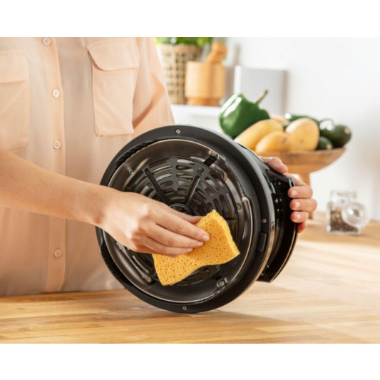 Person cleaning the Cook4me Accessory Extra Crisp Lid with a sponge