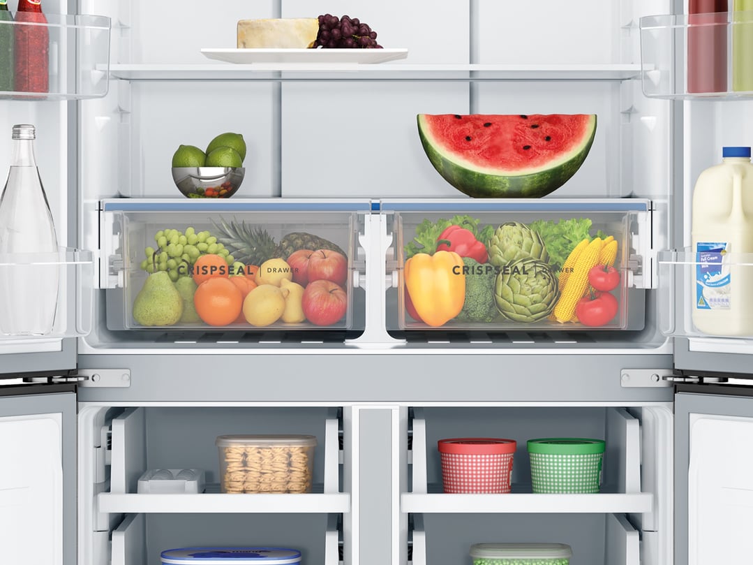 Open quad door refrigerator filled with fresh food and drinks