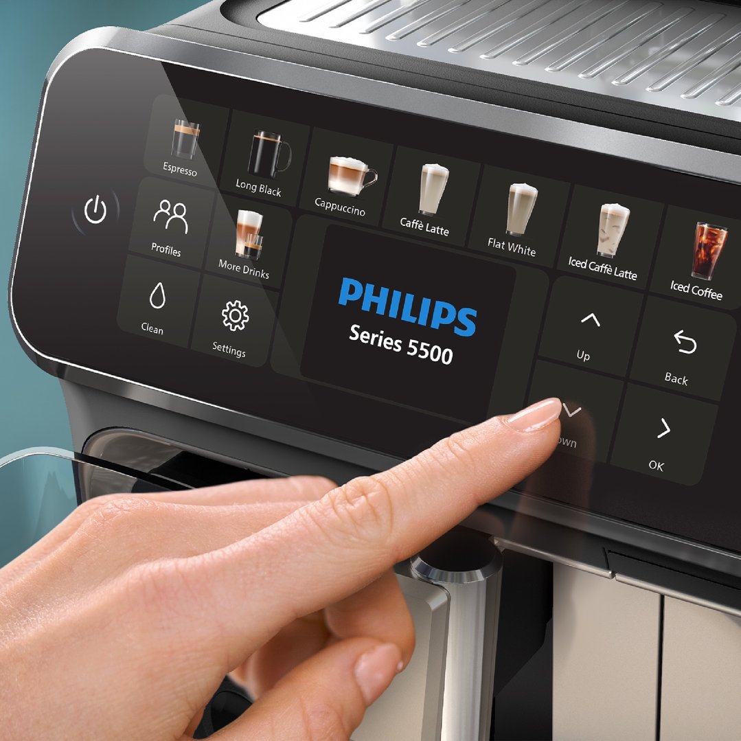 Hand touching the display of a Philips Series 5500 fully automatic espresso machine