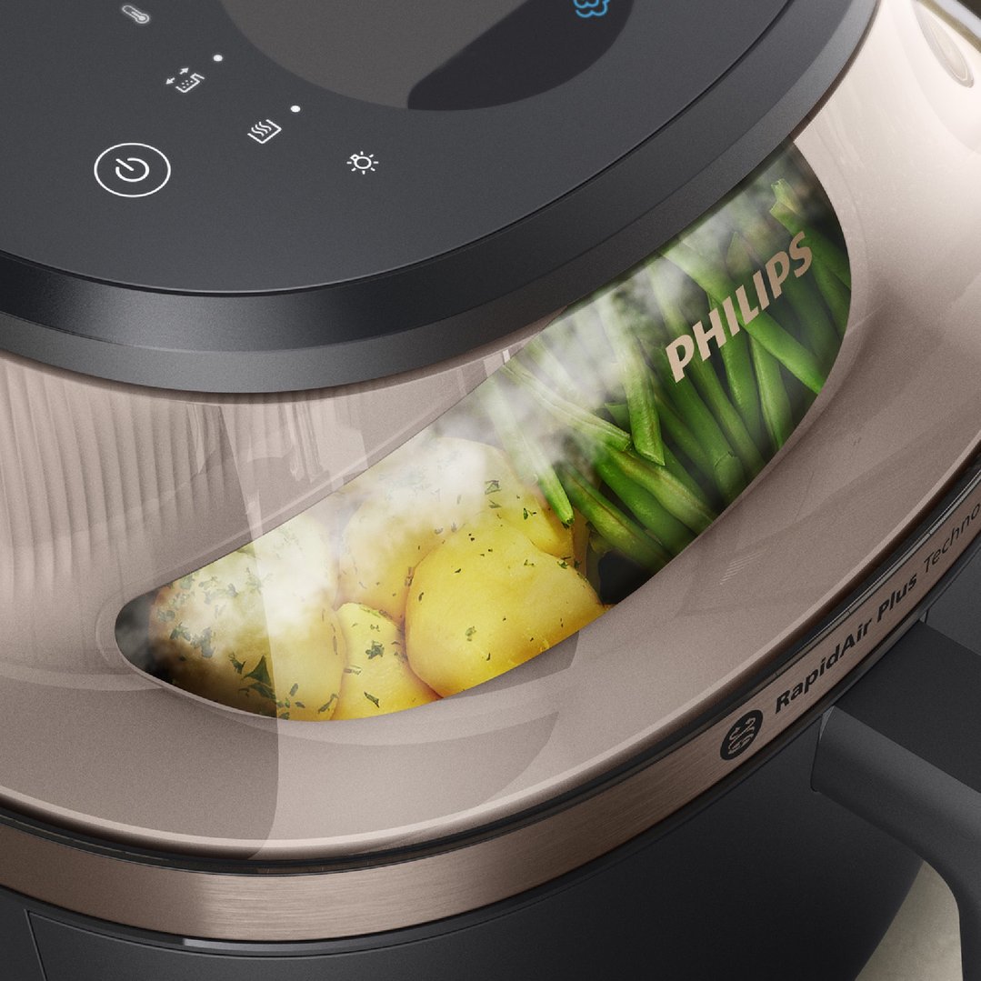 Close-up of a Philips airfryer cooking potatoes and green beans