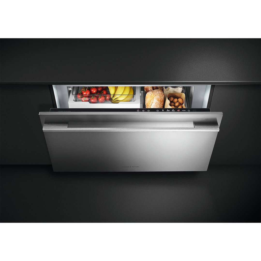 Open multi-temperature drawer with tomatoes, bananas, bread, and potatoes inside