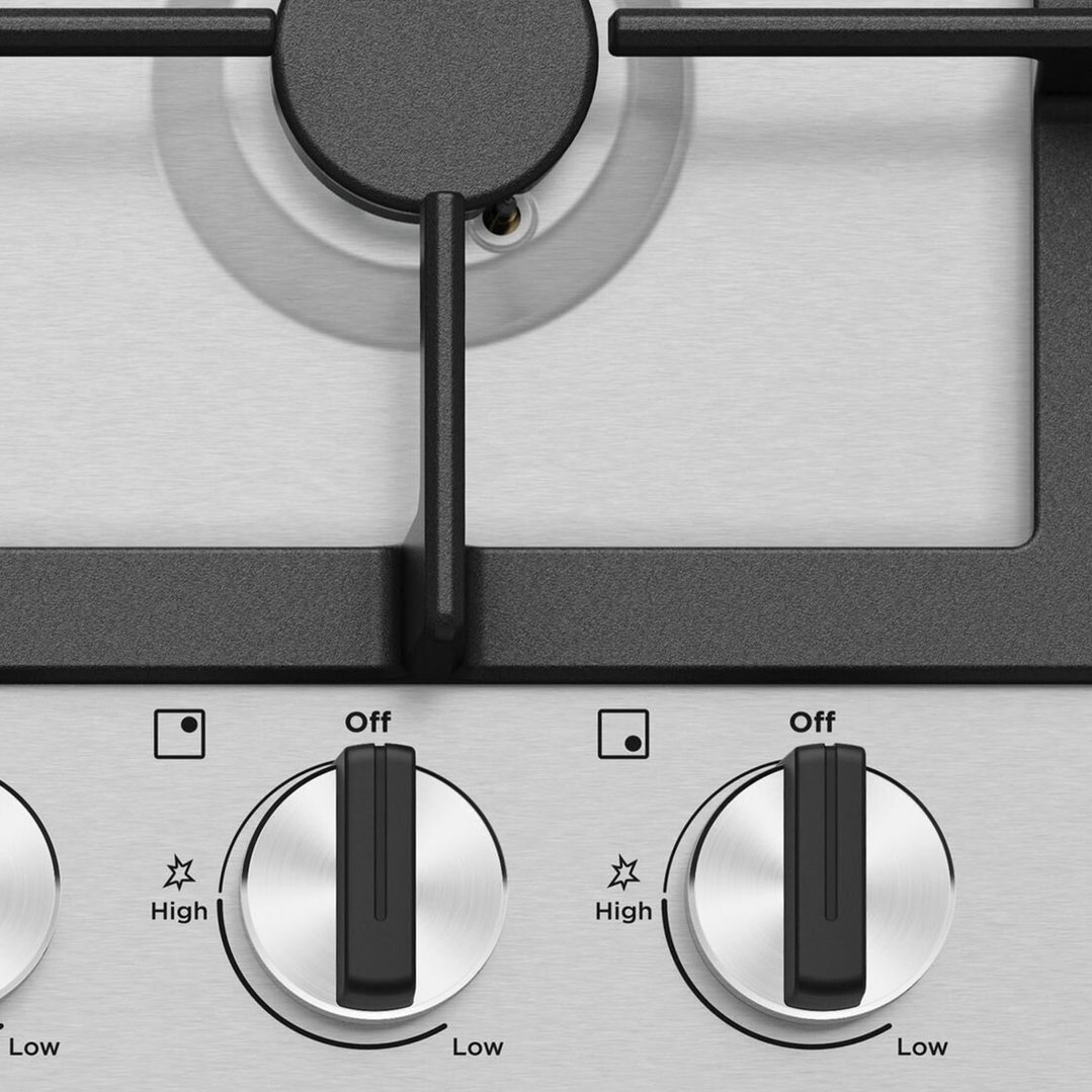 Close up of the control knobs on a gas cooktop