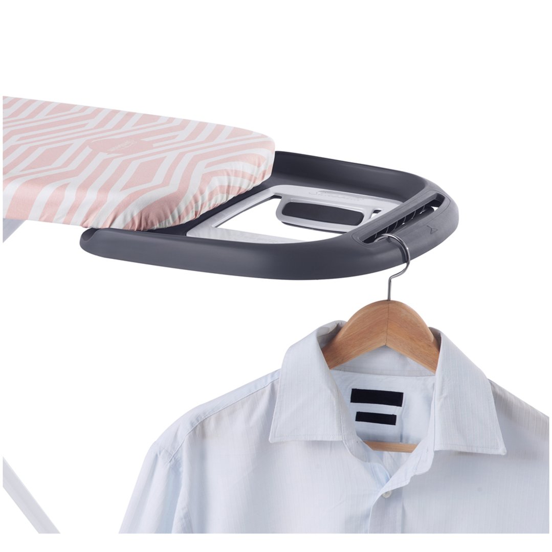 Close up of an ironing board with a shirt on a hanger