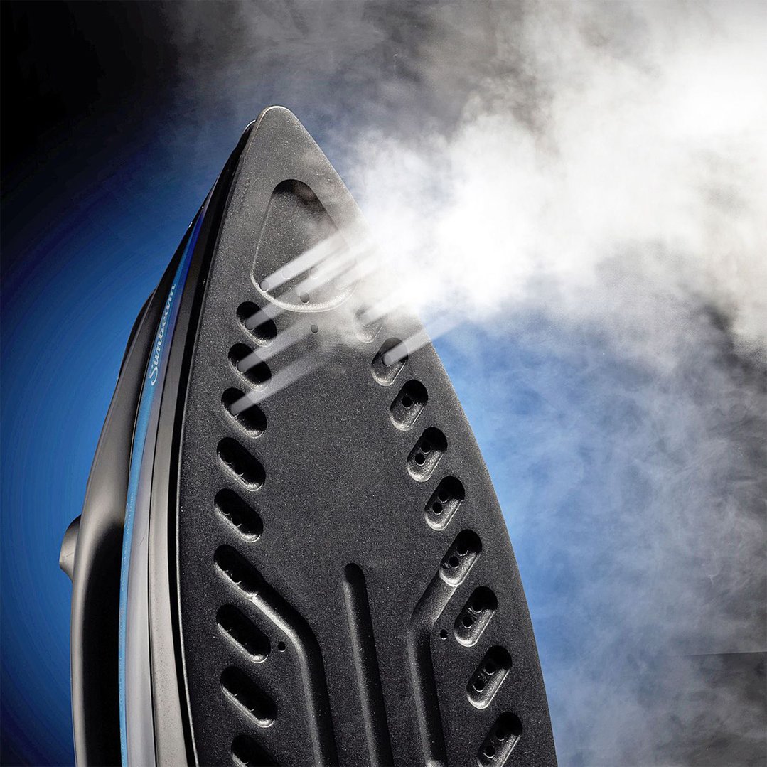 Close-up of a black and blue iron emitting steam against a blue background