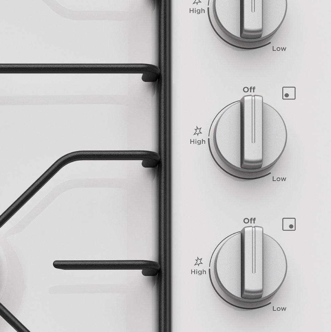 Close up of the control knobs and grates on a gas cooktop