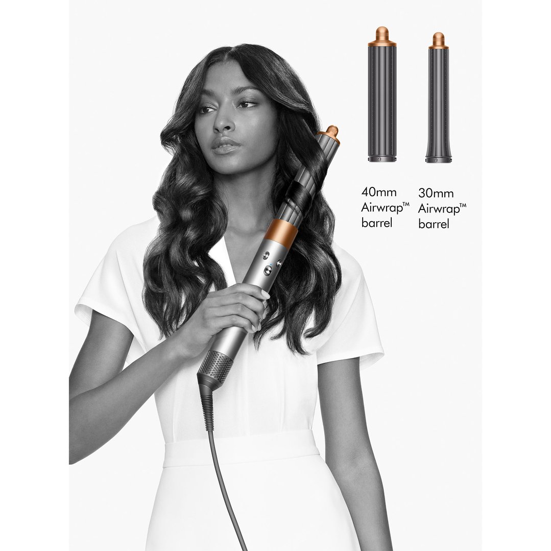Woman styling her hair with a Dyson Airwrap multi-styler, showing two barrel sizes