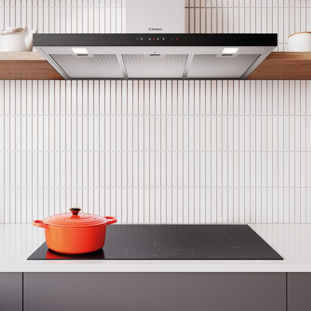 Westinghouse 90cm canopy rangehood installed above an induction cooktop with a pot