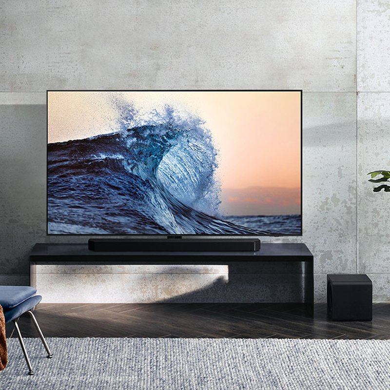 A soundbar and subwoofer on a stand in a living room with a TV
