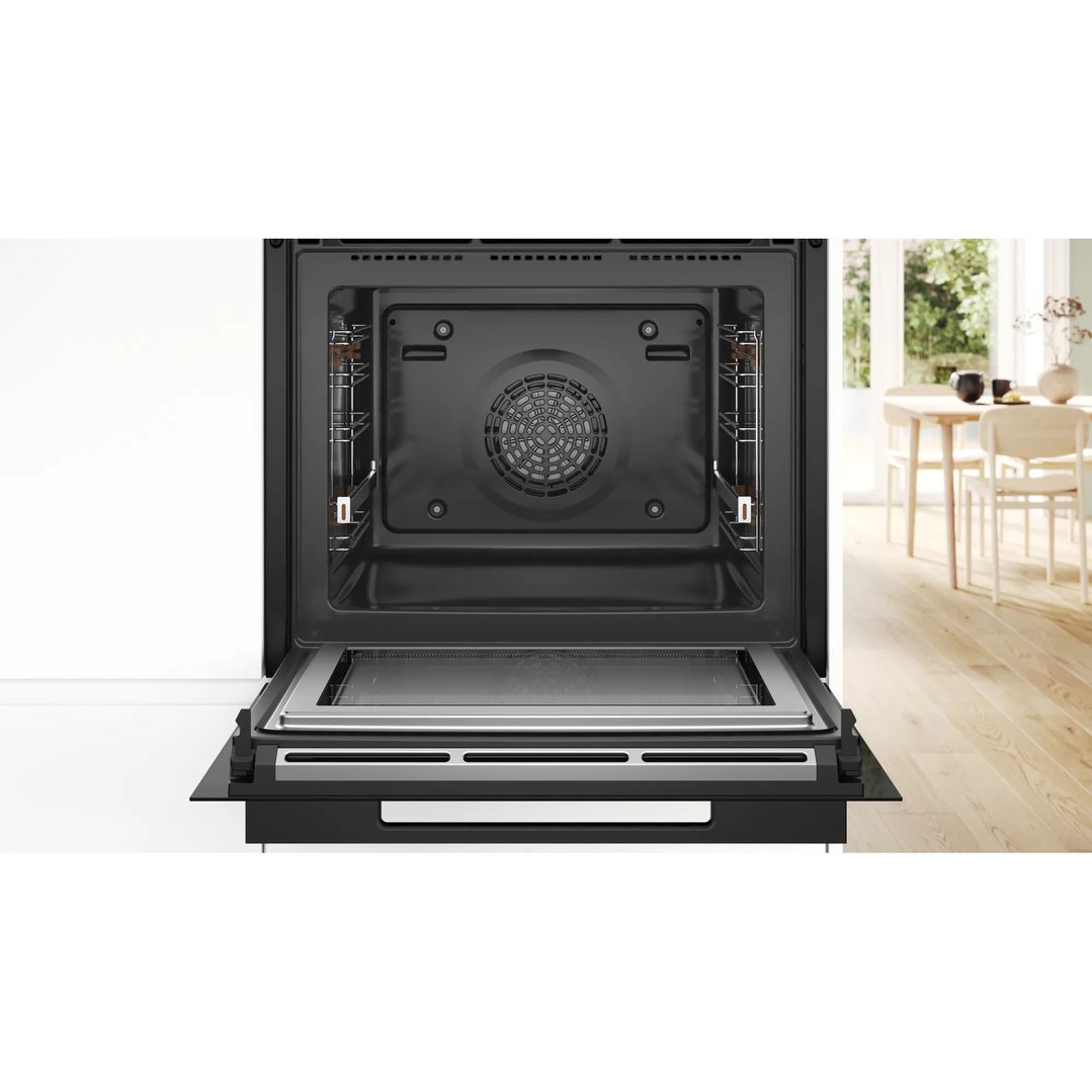 Open built-in oven with microwave and steam in a modern kitchen setting