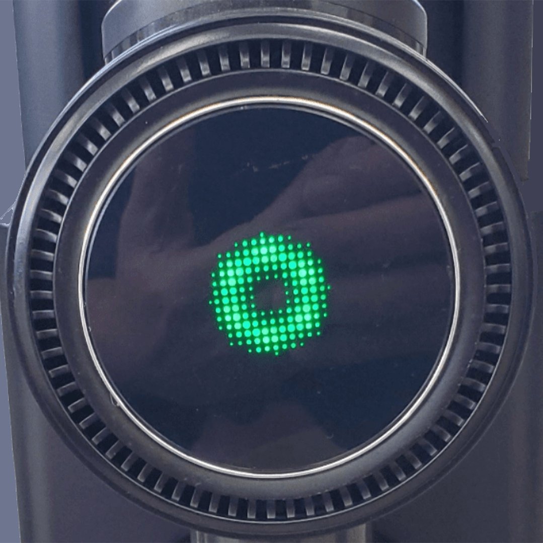 Close up of a vacuum cleaner display showing a green circular pattern