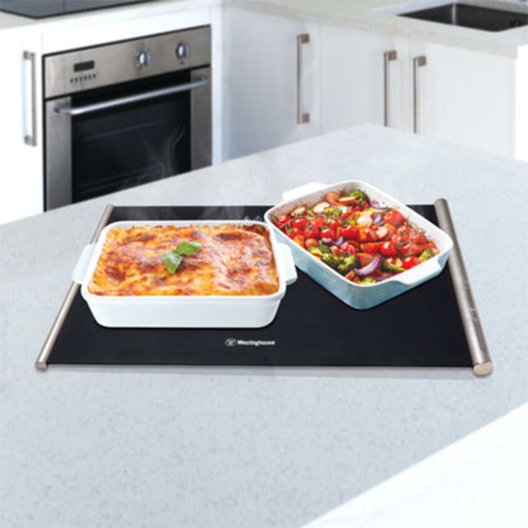 Westinghouse portable food warmer with two dishes of food on a kitchen counter