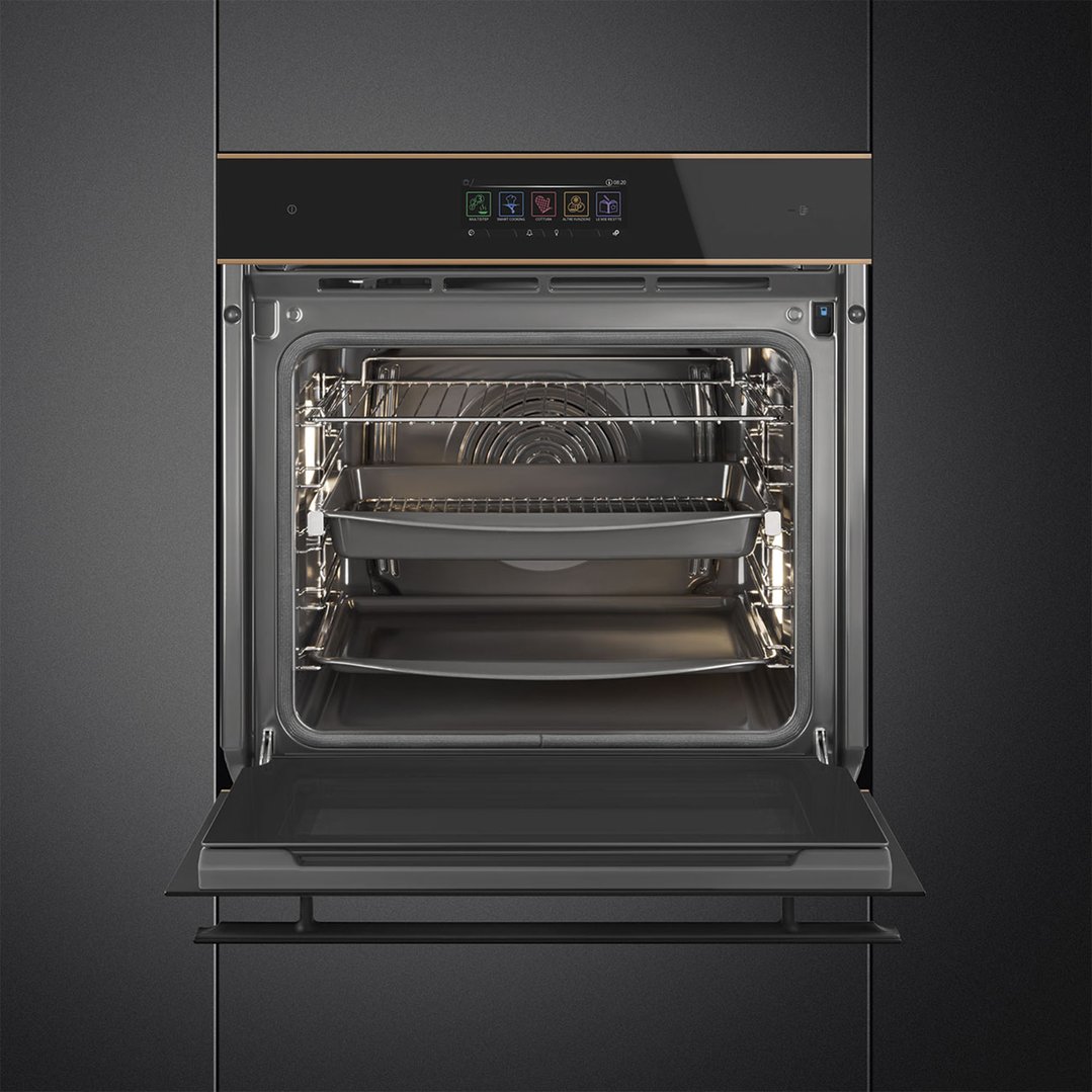 An open black glass oven with copper trim, showing the interior and control panel