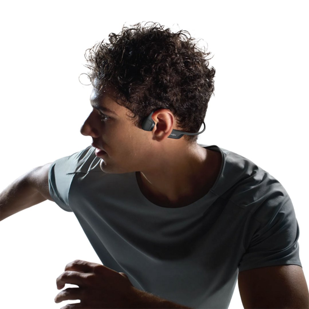 Man wearing black SHOKZ OpenRun Pro 2 headphones, looking left