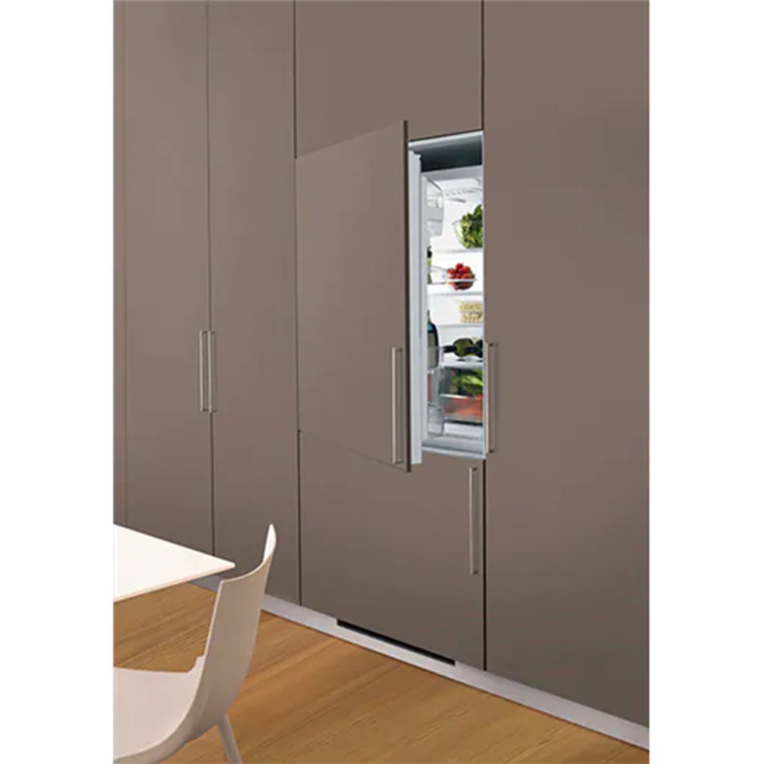 Built-in refrigerator with open door showing food in a modern kitchen