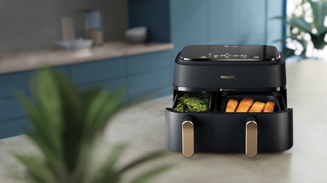 Philips 3000 Series Dual Basket Airfryer with food in a kitchen setting