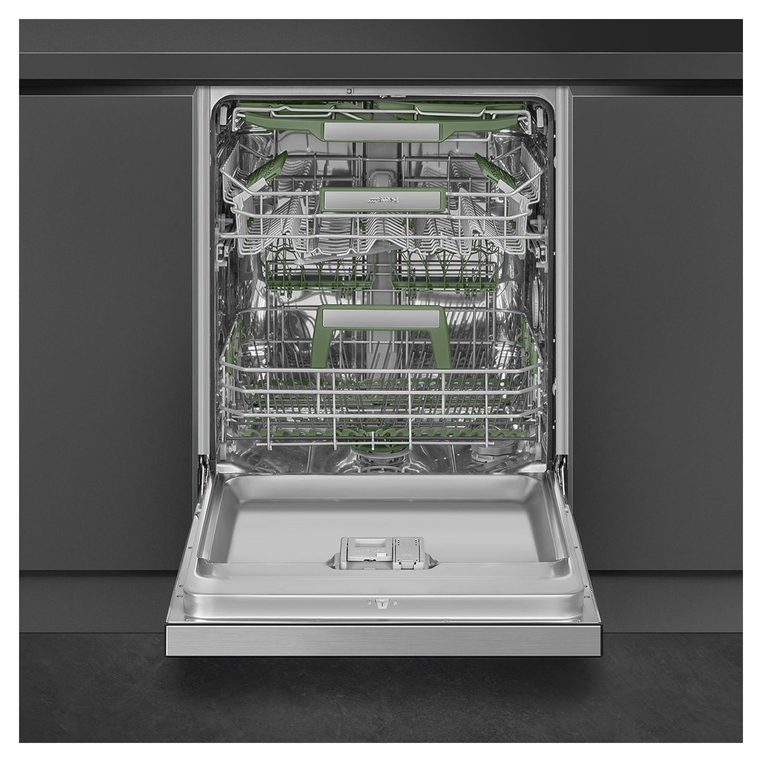 Open stainless steel dishwasher with green racks in a dark kitchen setting