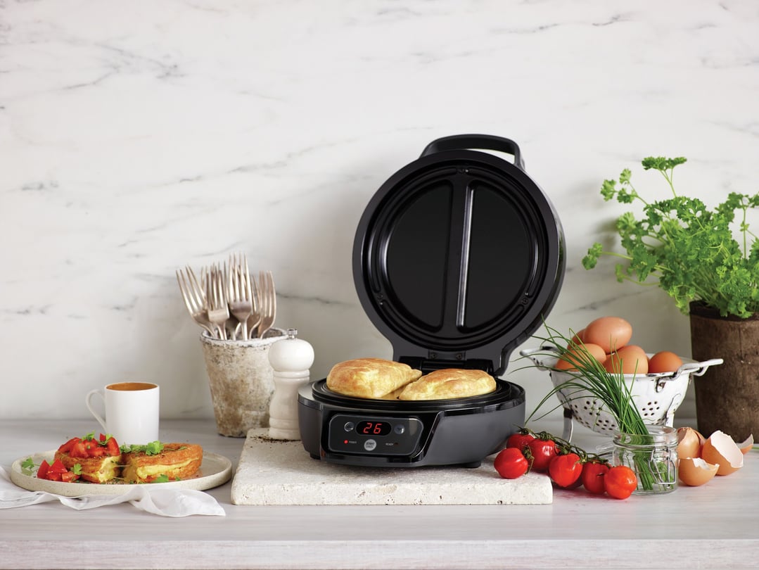 The Light and Fluffy novelty appliance cooking two omelets on a kitchen counter