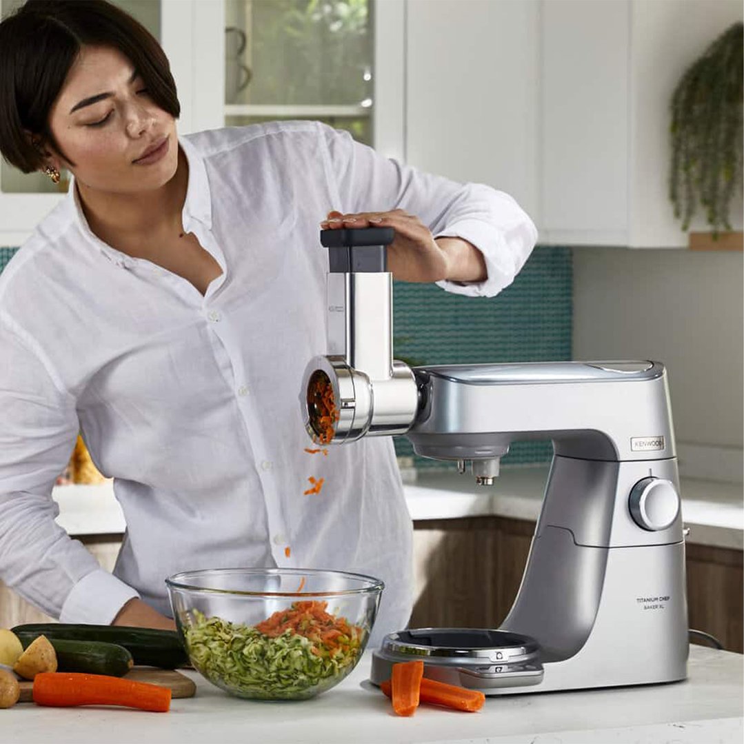 Woman using a Kenwood Rotary Slicer / Grater to shred vegetables