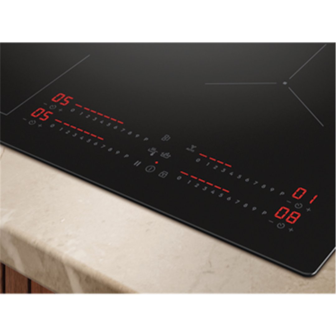 Close up of a black induction cooktop with red digital displays on a countertop